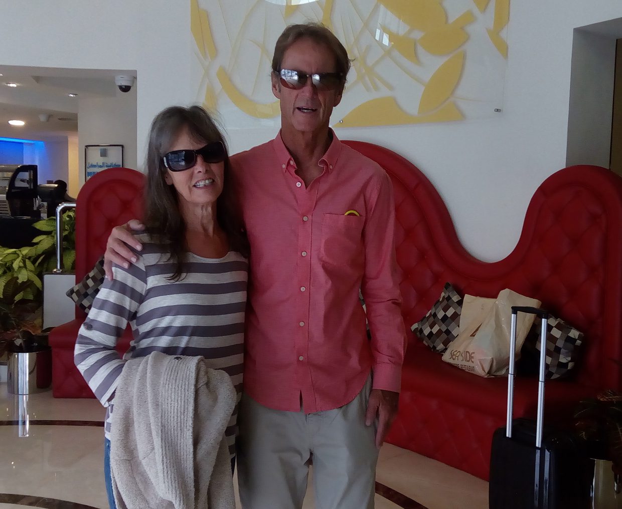 Couple in sunglasses posing indoors