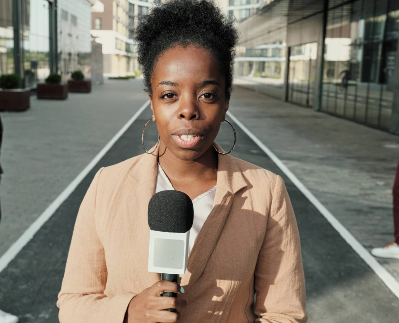 Reporter holding microphone on street