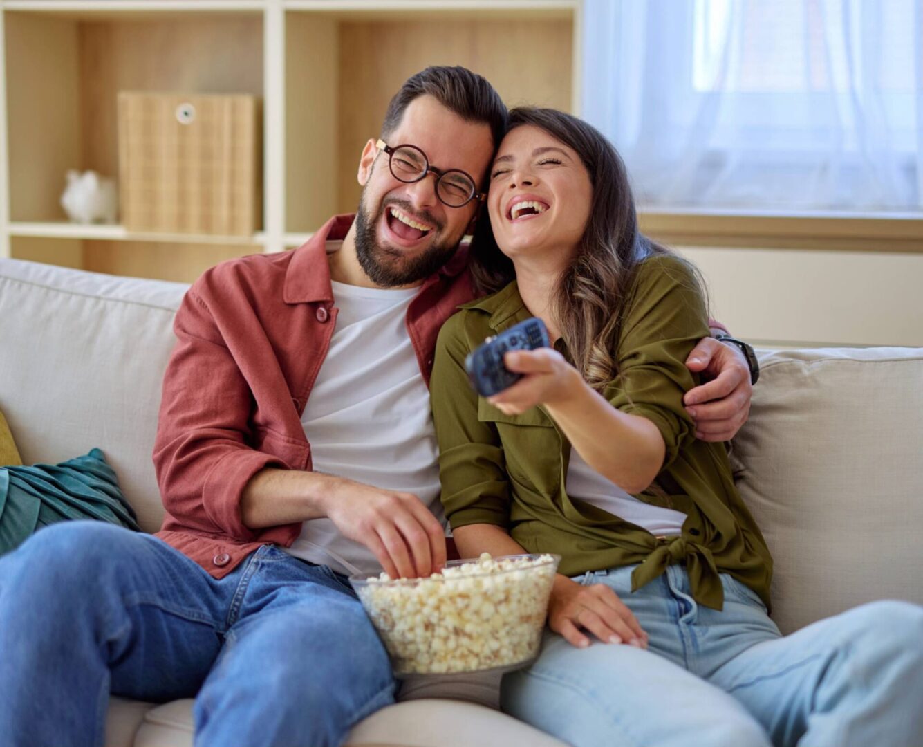 Happy pair watching TV together