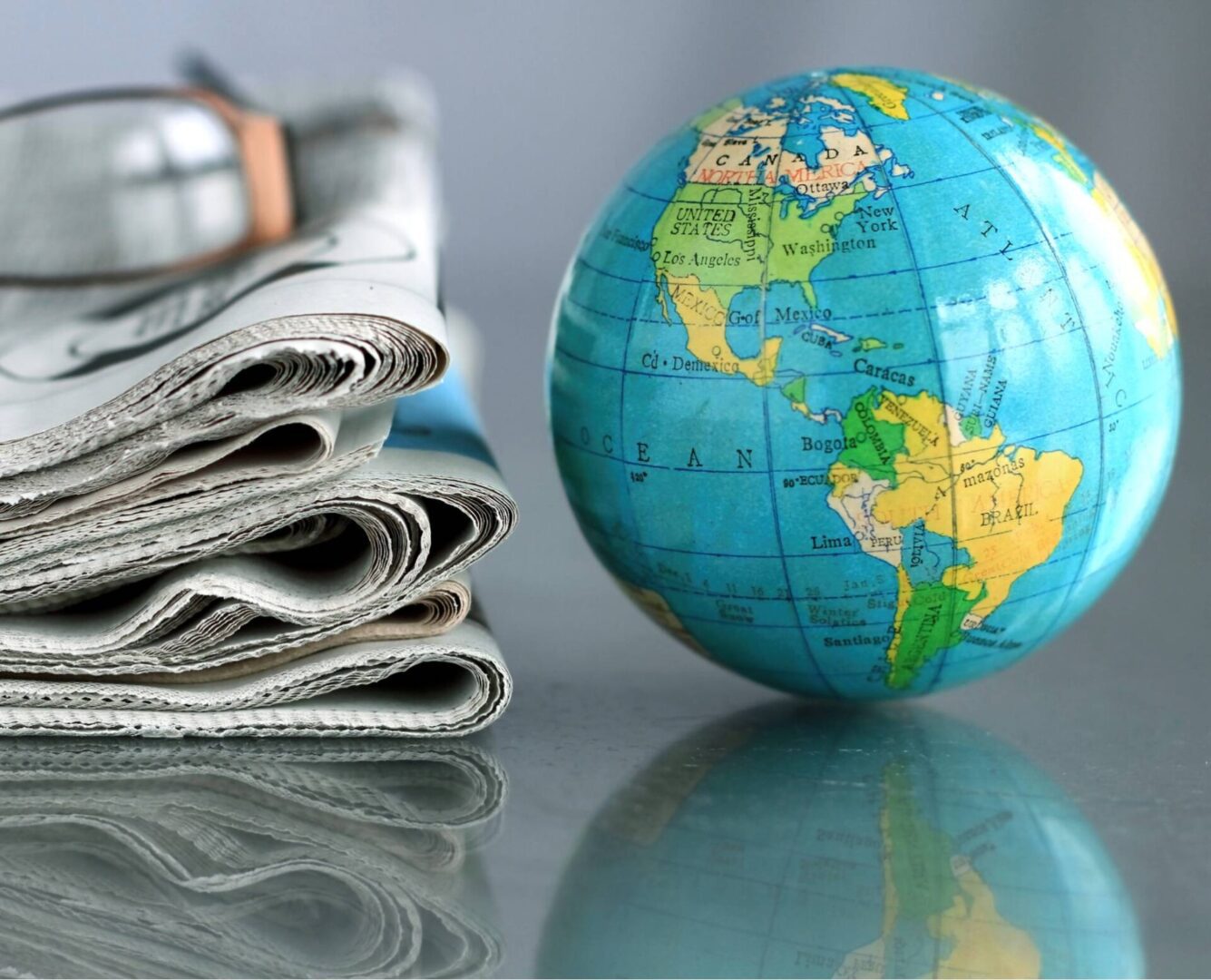 Small globe with glasses and newspapers
