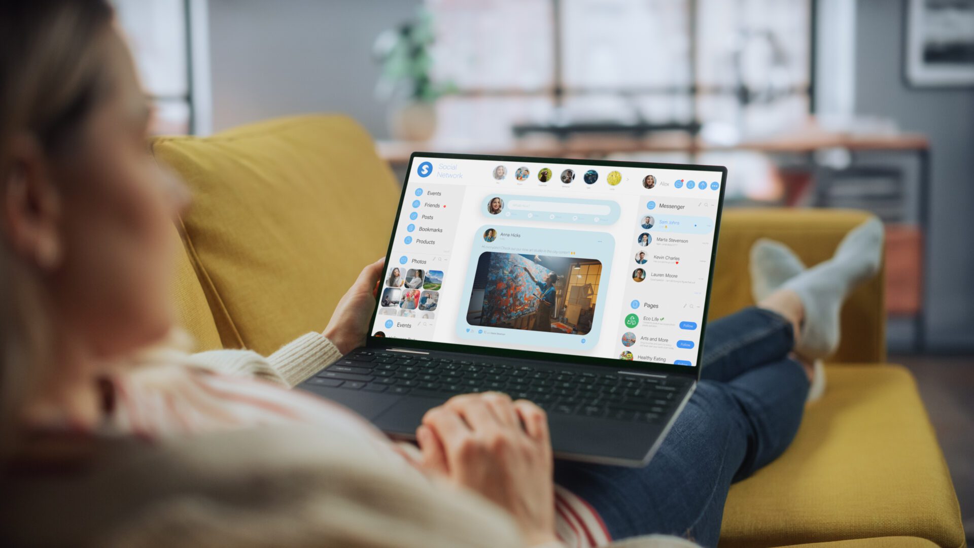Person using laptop on yellow sofa