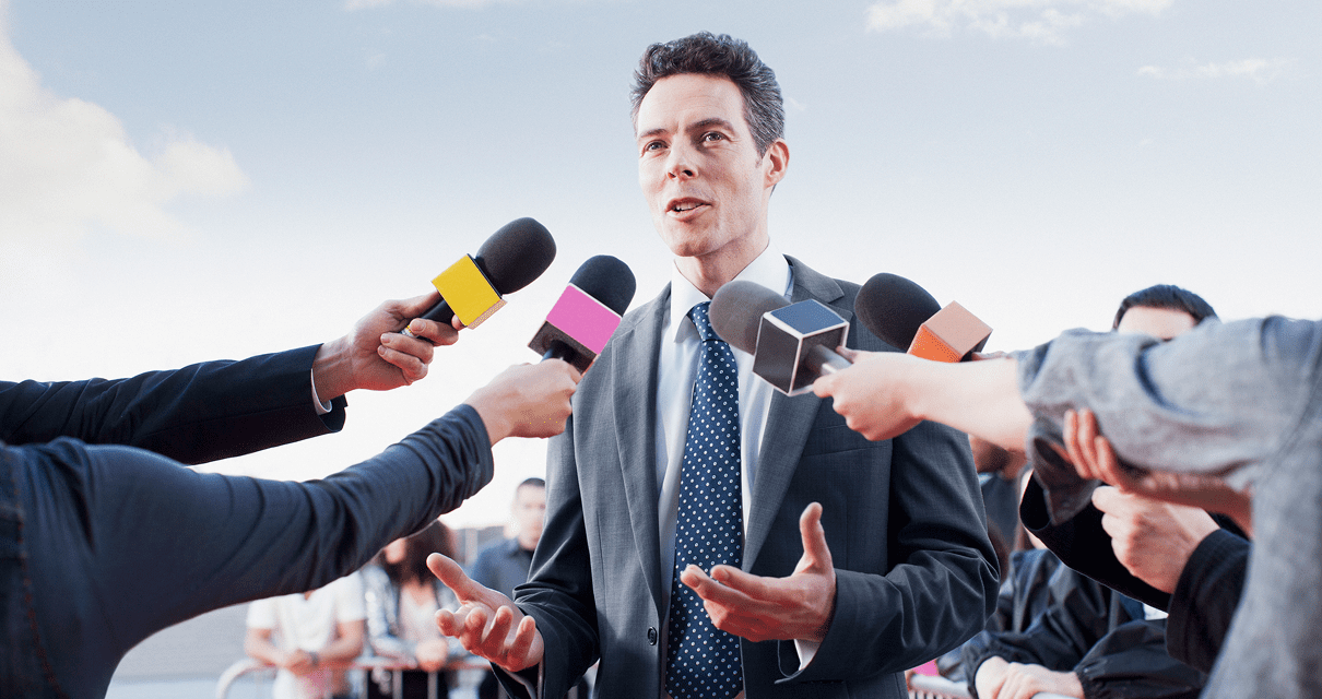 Business professional addressing media questions