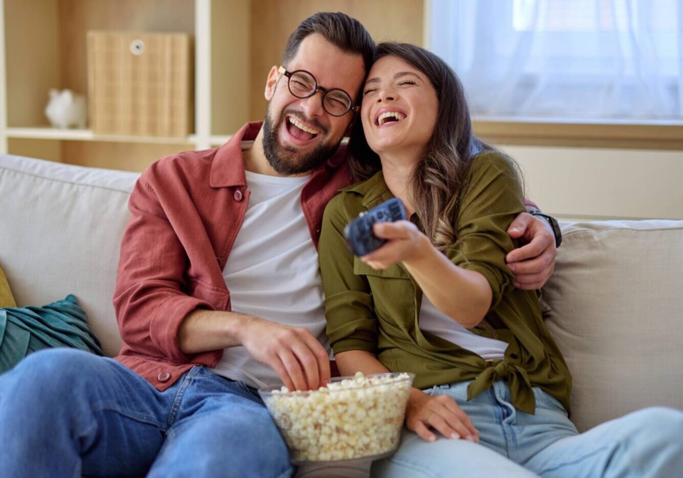 Happy pair watching TV together