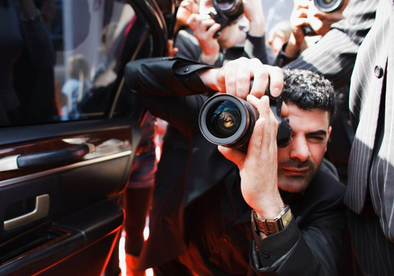 Photographer aiming camera at subject