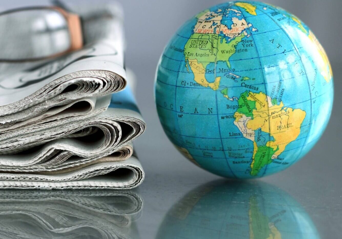 Small globe with glasses and newspapers