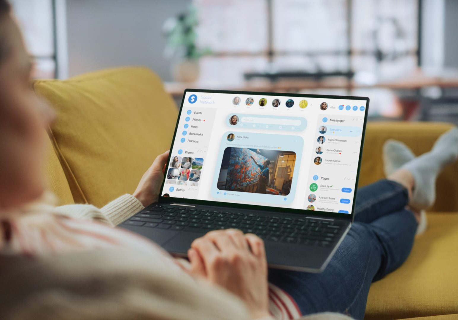 Person using laptop on yellow sofa